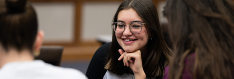 A smiling student engages in conversation during a Ford School event