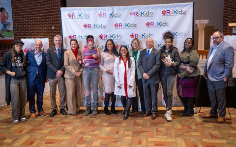 Photo of Gretchen Whitmer and Rx Kids co-directors Luke Shaefer; Dr. Mona Hanna-Attisha, and others in front of RxKids banner 