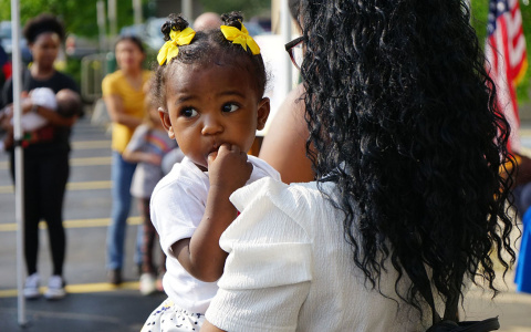 Woman holding baby at RxKids event