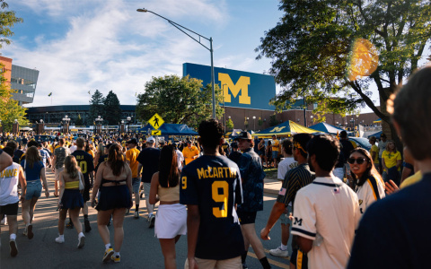 Photo of a crowd walking into Michigan Stadium.